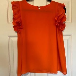Naked Zebra orange top with ruffle sleeves.